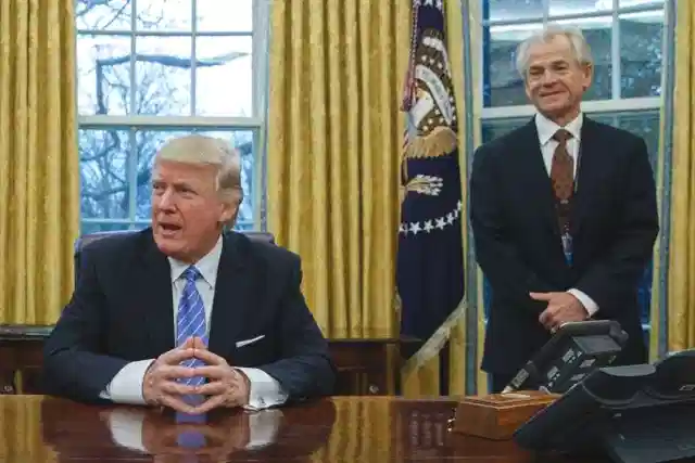 US President Trump with Navarro standing in the background. 