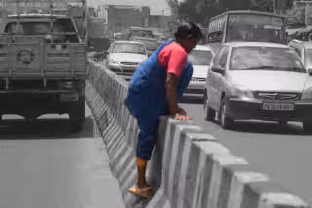 Lack of sufficient or accessible pedestrians streets and zebra crossings force peopel to risk their lives on India's motor-centric roads every day. A scene near Koyembedu in Chennai. (The Hindu)