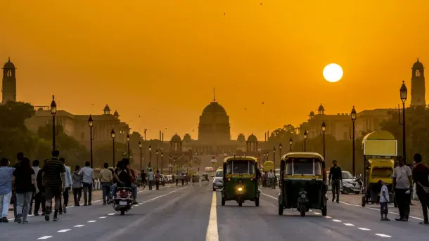 Vehicles and pedestrians on Kartavya Path leading to Rashtrapati Bhawan in New Delhi.