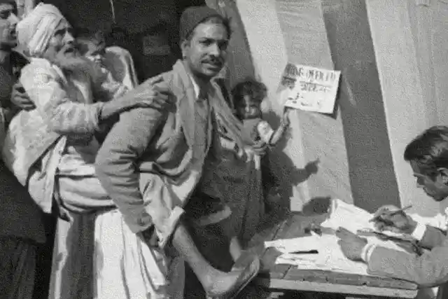 A man carrying an elderly voter to cast vote in the first Lok Sabha election 1951-52. (India Today)