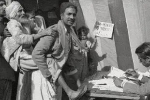 A man carrying an elderly voter to cast vote in the first Lok Sabha election 1951-52. (India Today)