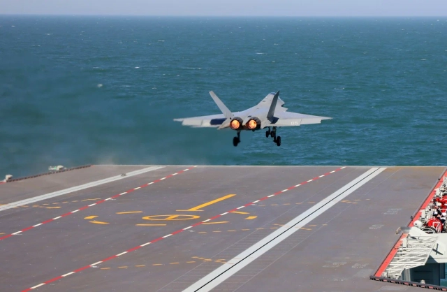 A Chinese fighter completes takeoff and landing drills on the flight deck of China’s new Fujian aircraft carrier.
