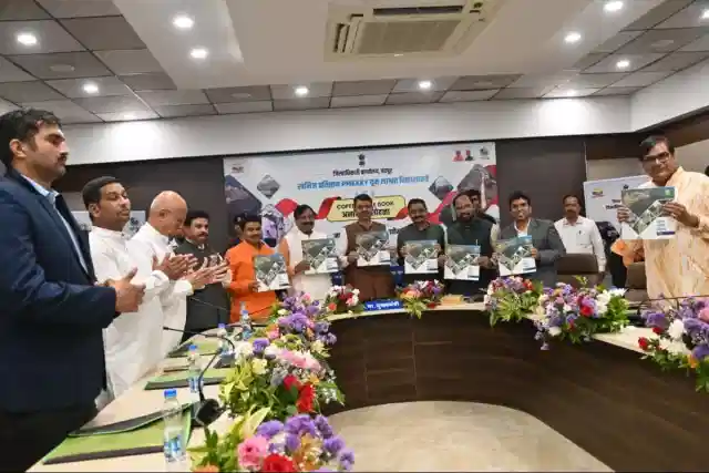 The chief minister unveiling a coffee table book produced by the District Mineral Foundation (DMF)