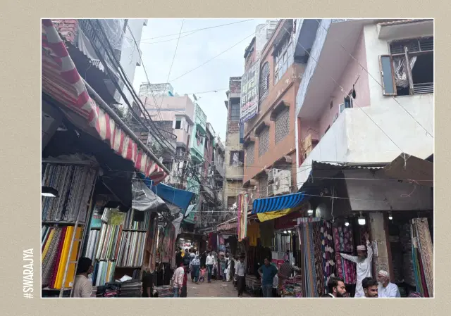 The lane is full of shops selling cosmetics, make up, utensils, and clothes.